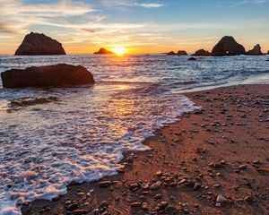 Preview wallpaper sea, beach, pebbles, rocks, sunset