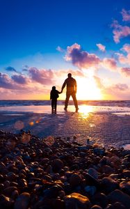 Preview wallpaper sea, beach, rocks, sunset, sun, rays, light