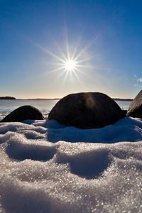 Preview wallpaper sea, beach, rocks, snow, light