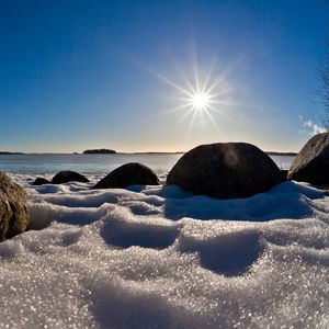 Preview wallpaper sea, beach, rocks, snow, light