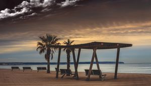 Preview wallpaper sea, benches, palms, rest, evening, clouds, starry sky