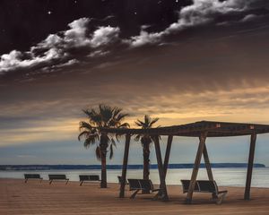 Preview wallpaper sea, benches, palms, rest, evening, clouds, starry sky