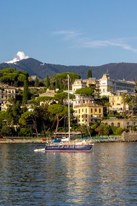 Preview wallpaper sea, boat, mast, buildings, houses, trees