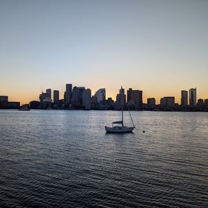 Preview wallpaper sea, boat, mast, buildings, city