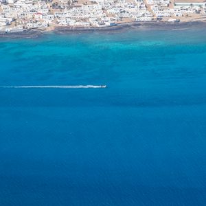 Preview wallpaper sea, boat, shore, buildings, aerial view