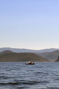 Preview wallpaper sea, boat, water, island, hills