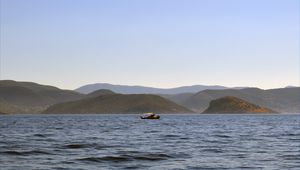 Preview wallpaper sea, boat, water, island, hills