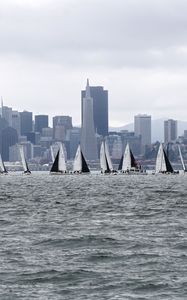 Preview wallpaper sea, boats, sails, skyscrapers, city