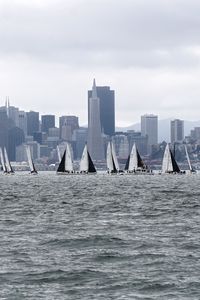 Preview wallpaper sea, boats, sails, skyscrapers, city