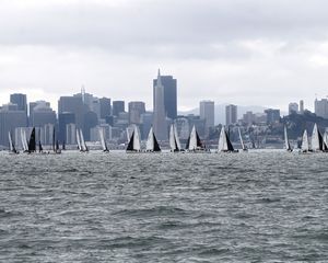 Preview wallpaper sea, boats, sails, skyscrapers, city