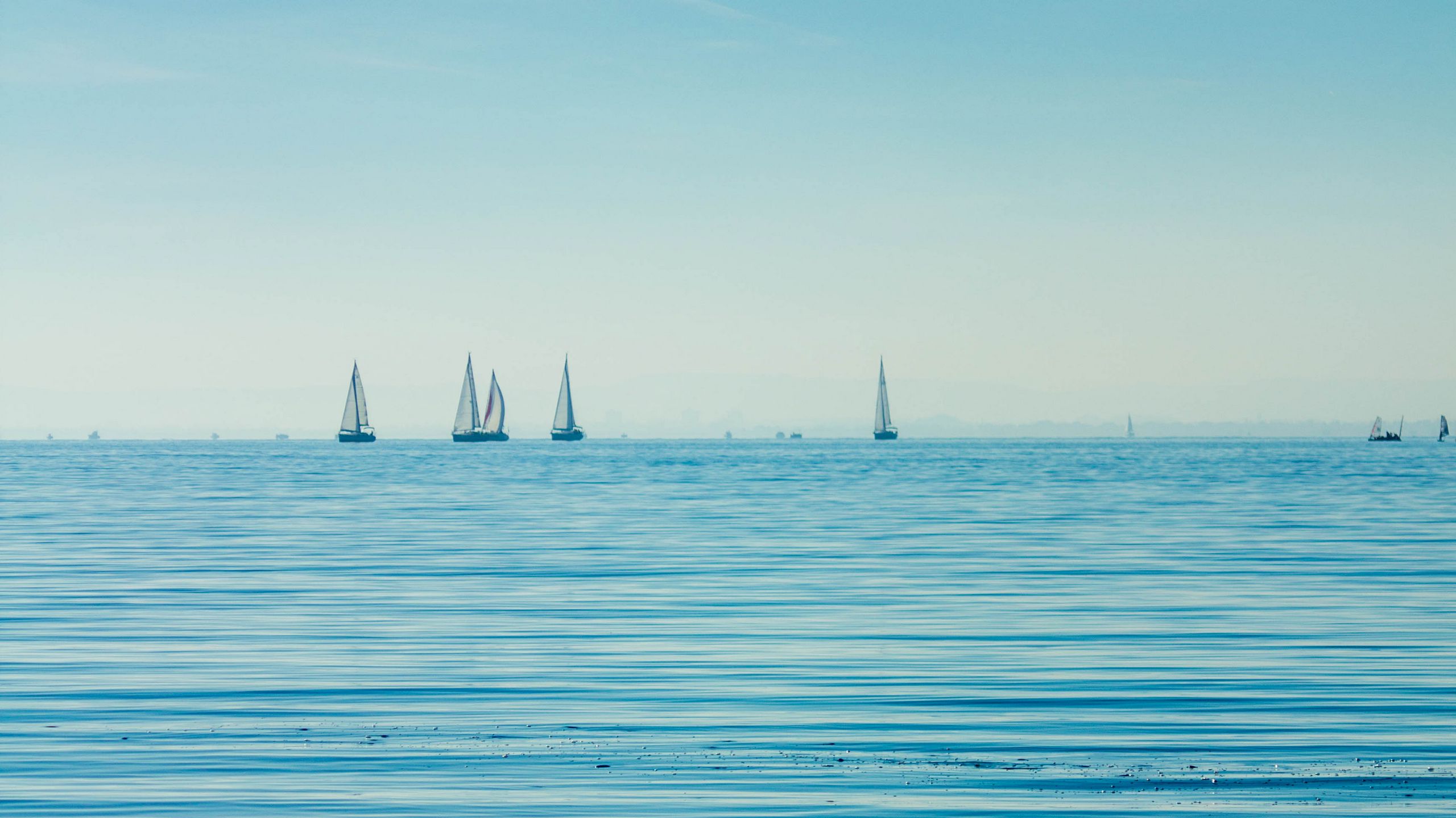 Download wallpaper 2560x1440 sea, boats, sails, horizon widescreen 16:9