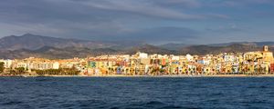 Preview wallpaper sea, buildings, mountains, city, clouds