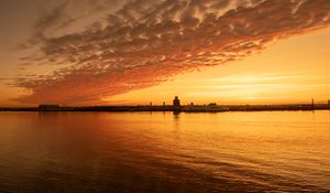 Preview wallpaper sea, buildings, silhouettes, sky, sunset