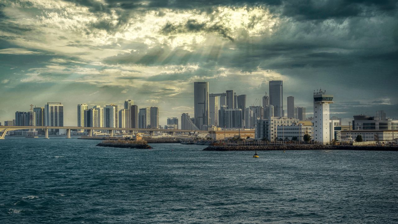 Wallpaper sea, city, clouds, waves, skyscrapers