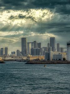 Preview wallpaper sea, city, clouds, waves, skyscrapers