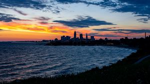 Preview wallpaper sea, city, coast, buildings, twilight