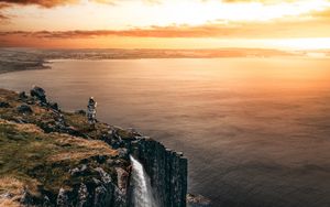 Preview wallpaper sea, cliff, waterfall, sunset, landscape