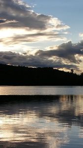 Preview wallpaper sea, clouds, horizon, evening, outlines, trees, reflection