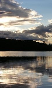 Preview wallpaper sea, clouds, horizon, evening, outlines, trees, reflection