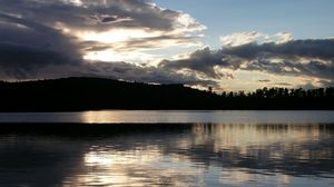 Preview wallpaper sea, clouds, horizon, evening, outlines, trees, reflection