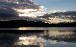 Preview wallpaper sea, clouds, horizon, evening, outlines, trees, reflection