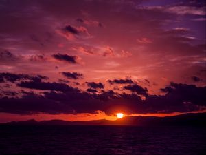 Preview wallpaper sea, clouds, mountains, sunset, dark