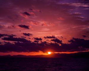 Preview wallpaper sea, clouds, mountains, sunset, dark