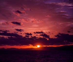 Preview wallpaper sea, clouds, mountains, sunset, dark
