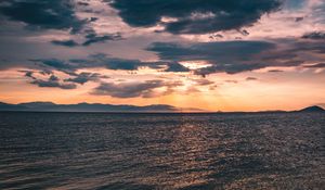 Preview wallpaper sea, clouds, sunlight, ripples, shore, mountains