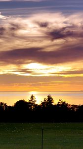 Preview wallpaper sea, clouds, trees, field, evening