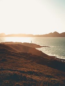 Preview wallpaper sea, coast, hills, lighthouse, sunlight