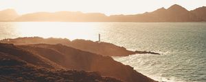 Preview wallpaper sea, coast, hills, lighthouse, sunlight