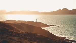 Preview wallpaper sea, coast, hills, lighthouse, sunlight