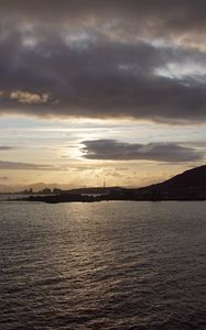 Preview wallpaper sea, coast, island, evening, clouds