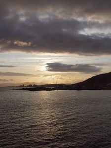 Preview wallpaper sea, coast, island, evening, clouds