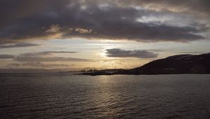 Preview wallpaper sea, coast, island, evening, clouds