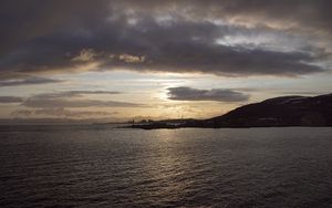 Preview wallpaper sea, coast, island, evening, clouds