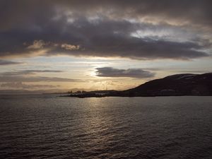 Preview wallpaper sea, coast, island, evening, clouds