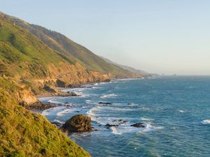 Preview wallpaper sea, coast, mountains, grass, landscape