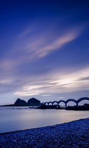 Preview wallpaper sea, coast, stones, bridge, sunset, evening