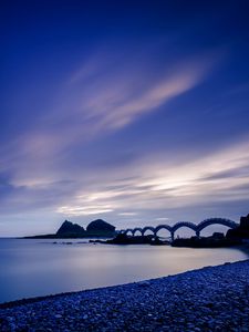 Preview wallpaper sea, coast, stones, bridge, sunset, evening