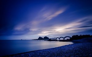 Preview wallpaper sea, coast, stones, bridge, sunset, evening