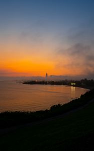 Preview wallpaper sea, coast, tower, clouds, evening, sky