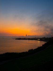 Preview wallpaper sea, coast, tower, clouds, evening, sky
