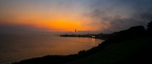 Preview wallpaper sea, coast, tower, clouds, evening, sky