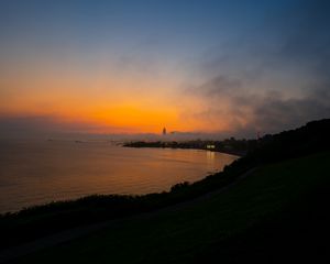 Preview wallpaper sea, coast, tower, clouds, evening, sky
