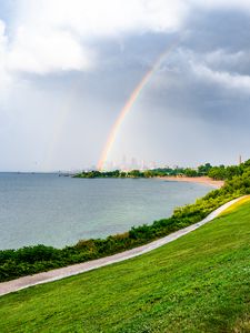 Preview wallpaper sea, embankment, rainbow, city, nature