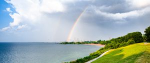 Preview wallpaper sea, embankment, rainbow, city, nature