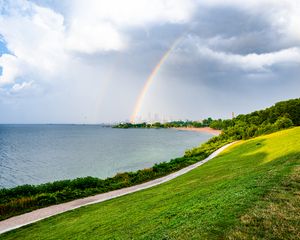 Preview wallpaper sea, embankment, rainbow, city, nature