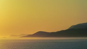 Preview wallpaper sea, hills, sunrise, landscape, nature